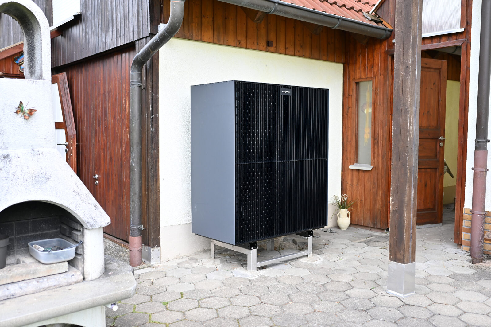 Anthrazitfarbene Viessmann Vitocal Wärmepumpe vor Holzfassade – fertig installiertes Projekt von Haustechnik DEK
